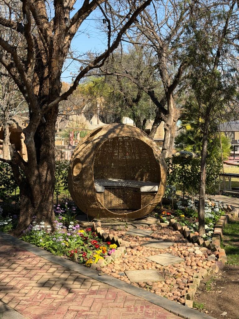 Garden seating beneath the trees at Seven Stones